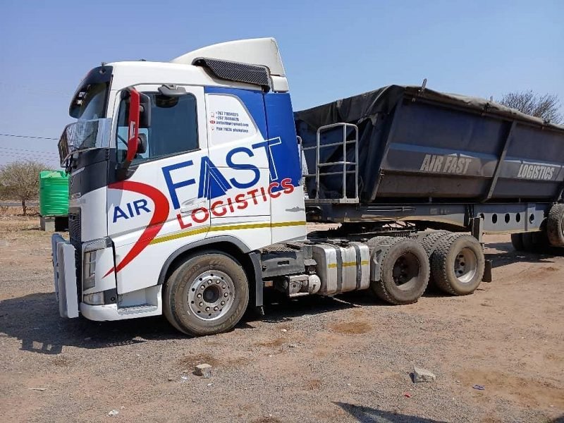 Volvo FH and side-tipper trailer in the Air Fast yard