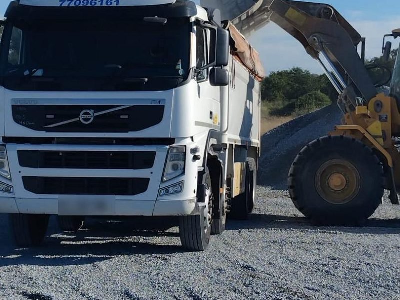 Volvo FM rigid tipper being loaded with aggregate by a front-end loader